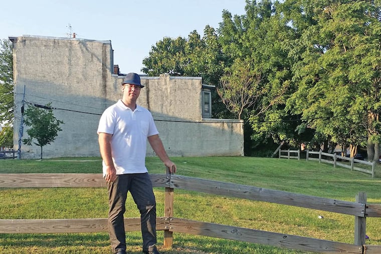 Adam Lang stands in front of 2047 Master Street, which he bought two years ago. Last month he received a massive bill from the Water Revenue Bureau even though there is no structure on the property.
