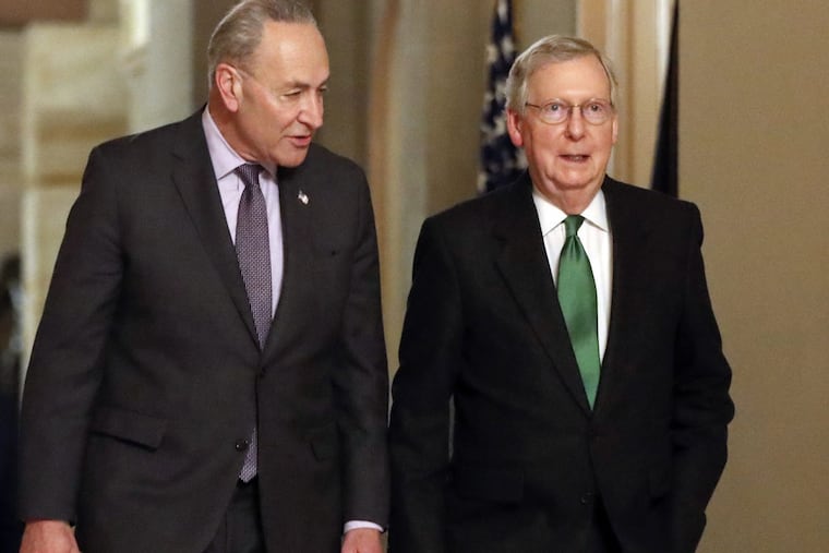 Senate Majority Leader Mitch McConnell, R-Ky., and Senate Minority Leader Chuck Schumer, D-N.Y., left, walk to the chamber after collaborating on an agreement in the Senate on a two-year, almost $400 billion budget deal that would provide Pentagon and domestic programs with huge spending increases, at the Capitol in Washington, Wednesday, Feb. 7, 2018.