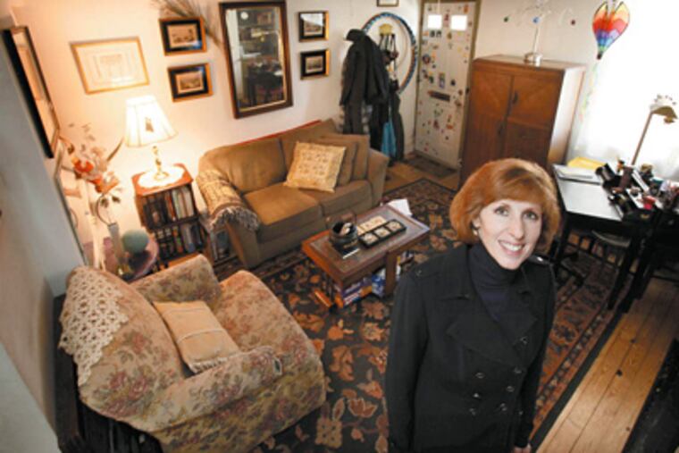 Cara Carroccia in the living room of her house on South Camac Street in Philadelphia. (Laurence Kesterson / Staff Photographer)
