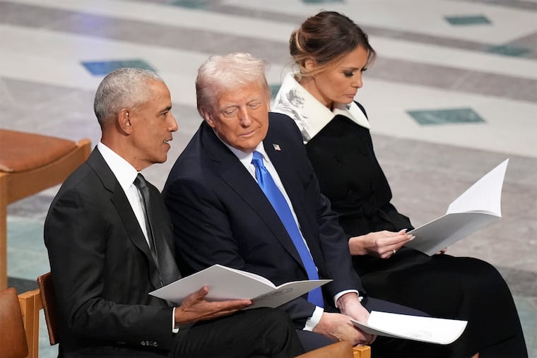 Former President Barack Obama talks with then President-elect Donald Trump as Melania Trump reads the funeral program before the state funeral for former President Jimmy Carter on Jan. 9, 2025, at Washington National Cathedral.