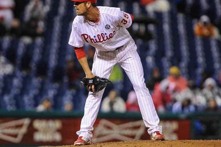 Cole Hamels struggled on a cold and rainy night, losing to the Mets.