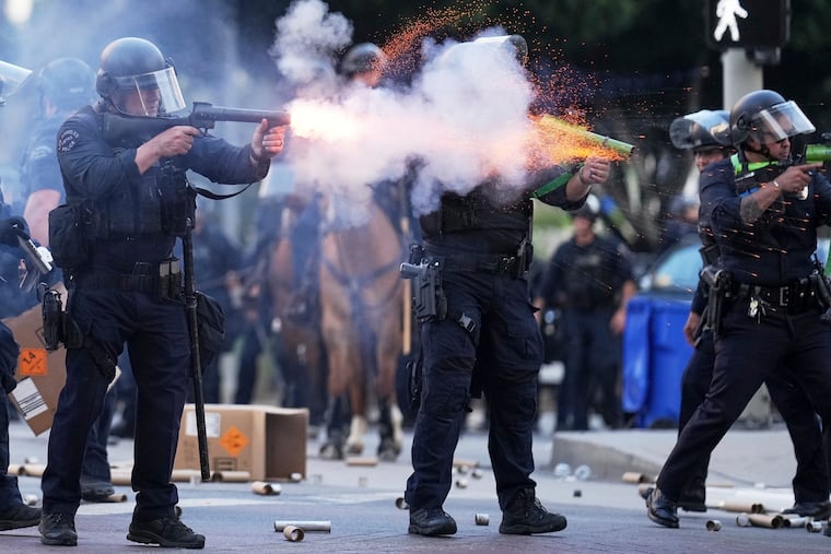 A police officer fires a soft round near the Metropolitan Detention Center in downtown Los Angeles on Sunday, June 8, 2025, during an immigration protest.