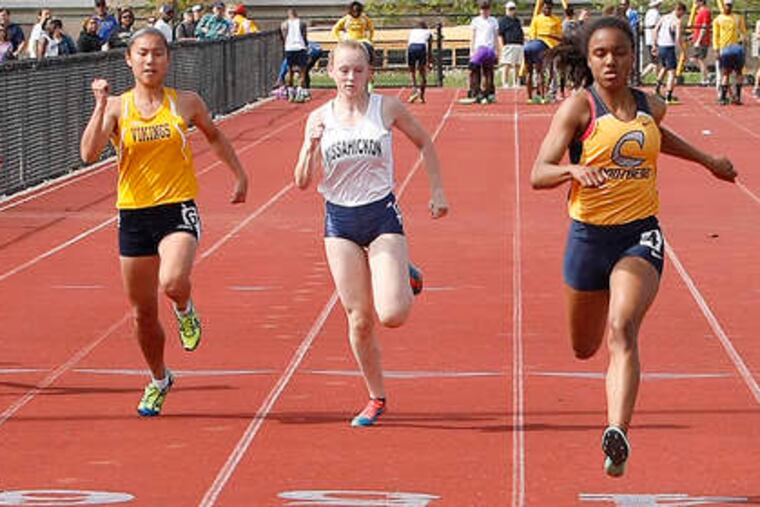 Cheltenham's Katelyn Jackson (center) wins the 100-meter dash, running it in 12 seconds flat.