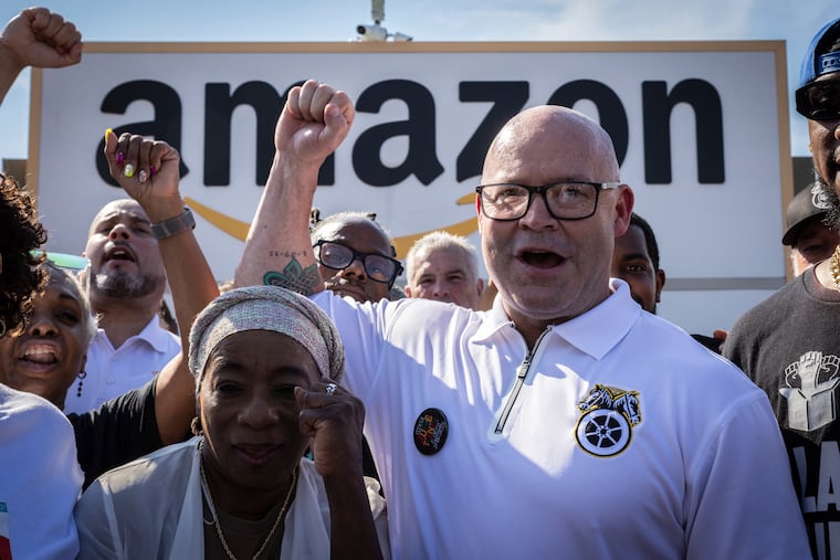 Teamsters General President Sean M. O'Brien, center, rallies with Amazon workers outside the Staten Island Amazon facility JFK8 in June in New York.