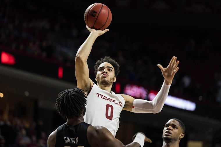 Senior forward Obi Enechionyia attempts a jump shot during the Owls' game against UCF at The Liacouras Center on Sunday, February 25, 2018. SYDNEY SCHAEFER / Staff Photographer