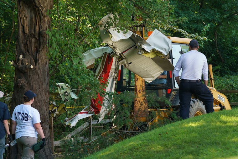 NTSB investigators removing wreckage of a single-engine plane that crashed in a residential neighborhood in Upper Moreland, killing two Philadelphia doctors and their 19-year-old daughter.