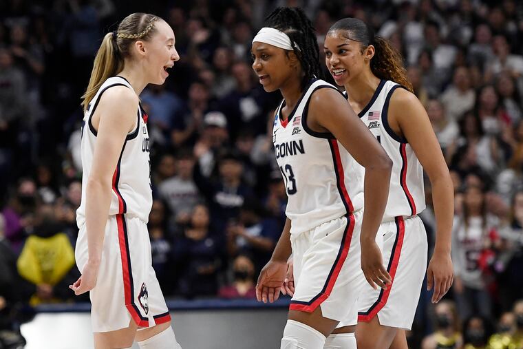 Paige Bueckers, Christyn Williams and Evina Westbrook (from left to right) celebrate during the second half of UConn's win.