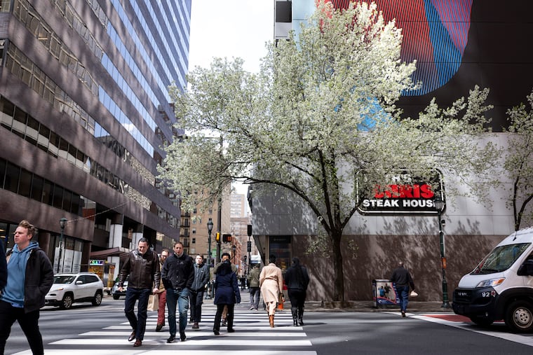 People crossing the street at 18th and Market during a cold day in Philadelphia on Tuesday.