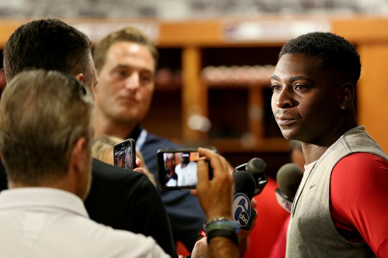 Didi Gregorius, right, talks with reporters inside the clubhouse at the start of spring training.