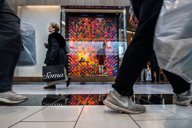 Shoppers walk near Louis Vuitton during Black Friday 2019 at the King of Prussia Mall. Because of the pandemic, pre-Black Friday sales have been going on for a while already this year.