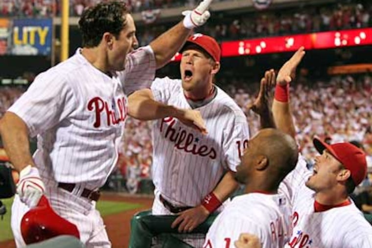 Pat Burrell is greeted by teammates after his go-ahead solo homer in the sixth inning of Game 1 of the NLCS. (Jerry Lodriguss / Staff Photographer)