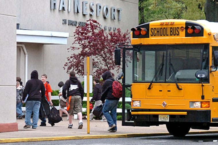 A Hainesport school bus drops students off at school this morning. The school reopened today after being closed for two days as a precaution after two students complained of flu-like symptoms.