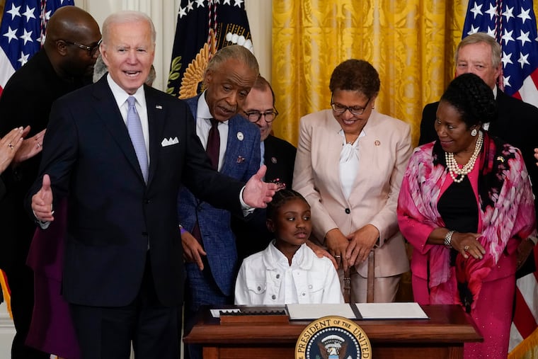 President Joe Biden speaks as Gianna Floyd, the daughter of George Floyd, sits in the chair after Biden signed an executive order in the East Room of the White House on Wednesday.