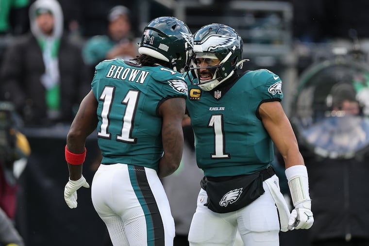 Eagles wide receiver A.J. Brown celebrates his third quarter touchdown reception with Jalen Hurts on Sunday.