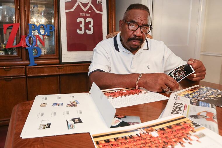 Thomas Vaughan looks over family photos of his grandson Zion at his home in Yeadon.