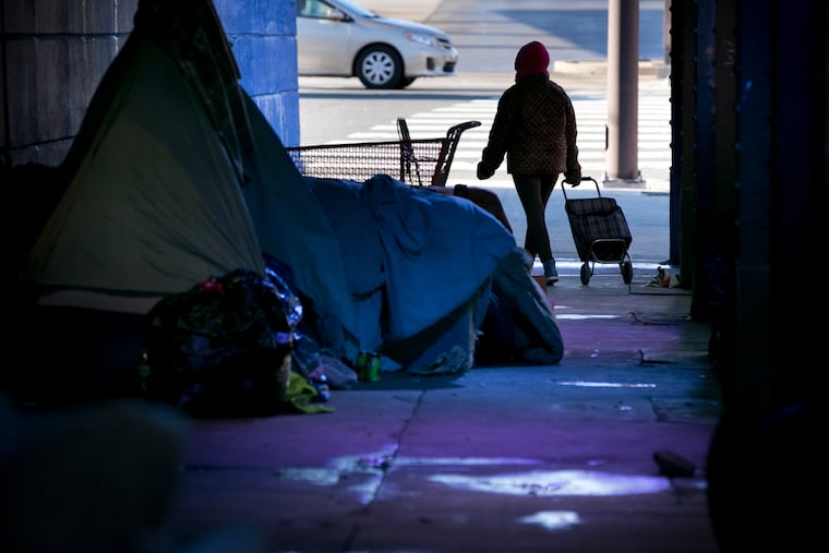 A woman walks through an area in Kensington, near where there are plans for a supervised injection site.