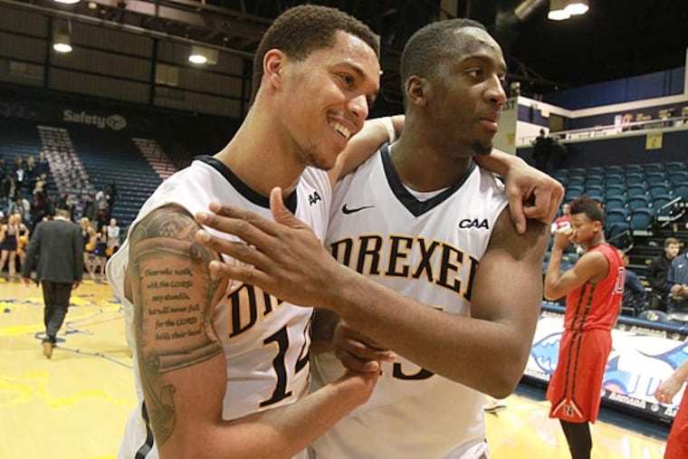Damion Lee (left) is hugged by Mohamed Bah after. (Charles Fox/Staff Photographer)
