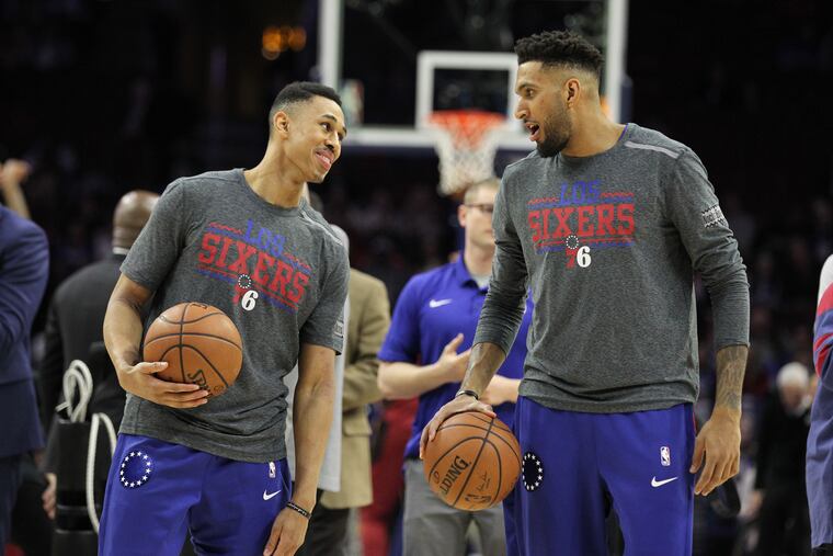 Zhaire Smith, left, of the Sixers and Jonah Bolden talk during warm-ups at Wells Fargo Center on March 12, 2019.
