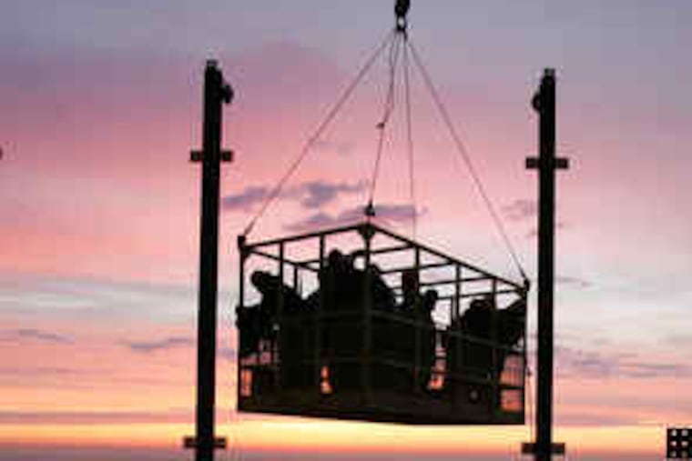 Iron workers began another day of work on the Comcast Center at sunrise in March 2007, being hoisted to the 51st floor. By 2029, what we think of as Center City may extend to the Penn and Temple campuses.