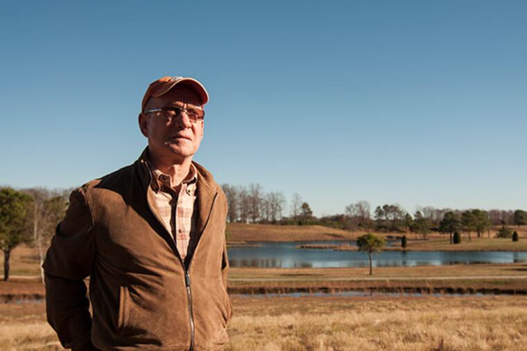 Henry McNiel, who is selling land to Winslow township, stands infront of the lake he crafted over the years. McNiel took the purchasing parties on a tour of his expansive part of Winslow Township NJ. (PATRICK MCPEAK/STAFF PHOTOGRAPHER)