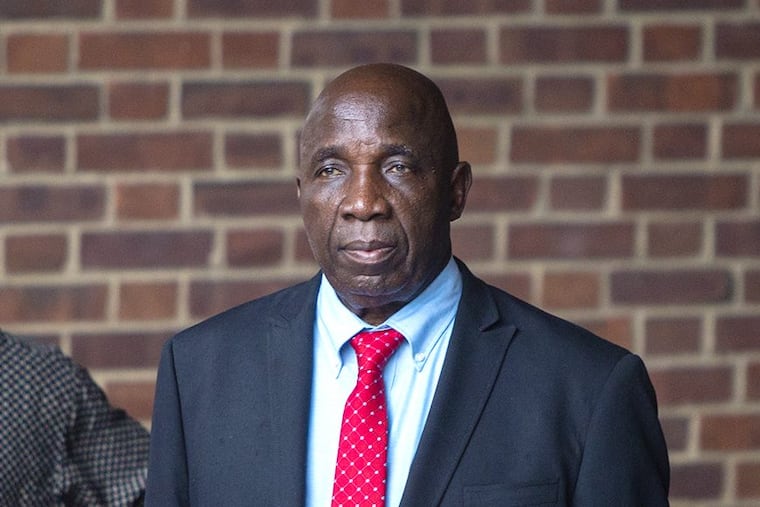 Tom Woewiyu stands outside the federal courthouse in Philadelphia with his family on July 3, 2018, after he was convicted of hiding past as Liberian war criminal.