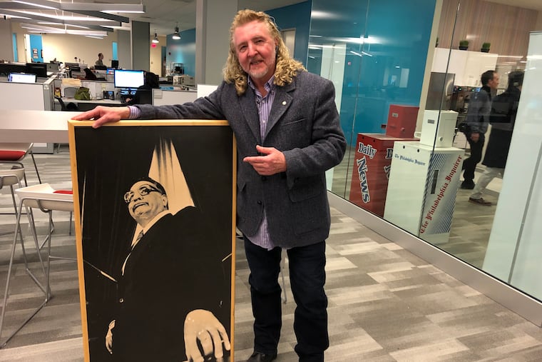 Former Philadelphia Daily News photographer Norman Y. Lono retrieving a framed blow-up of his Frank Rizzo portrait in our newsroom Wednesday, Feb. 13, 2019.