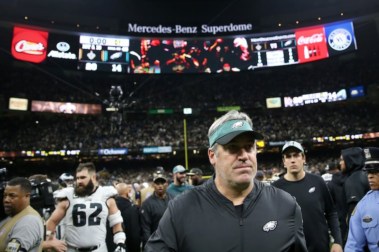 Eagles head coach Doug Pederson walks off the Superdome field after the loss to the Saints.