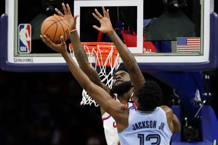 Sixers forward Norvel Pelle reaches for the basketball against Memphis Grizzlies forward Jaren Jackson in February.