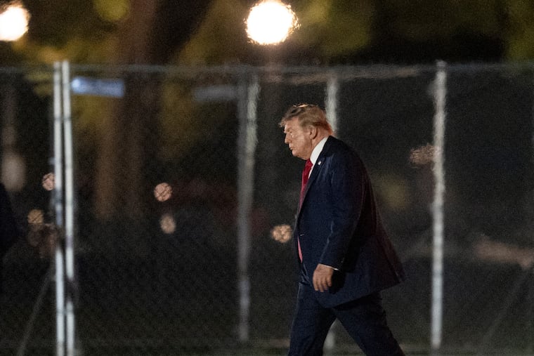 President Donald Trump walks on the Ellipse as he arrives on Marine One near the White House on Friday.