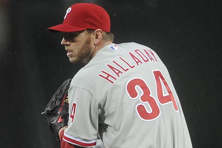 Philadelphia Phillies pitcher Roy Halladay works against the Atlanta Braves during a baseball game, Wednesday, April 3, 2013, in Atlanta. Atlanta won 9-2. (AP Photo/John Amis)
