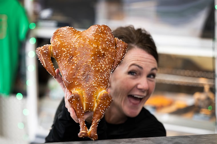 Melissa Luchansky, a staffer at the Philly Pretzel Factory in Langhorne, shows off the store's turkey pretzel.