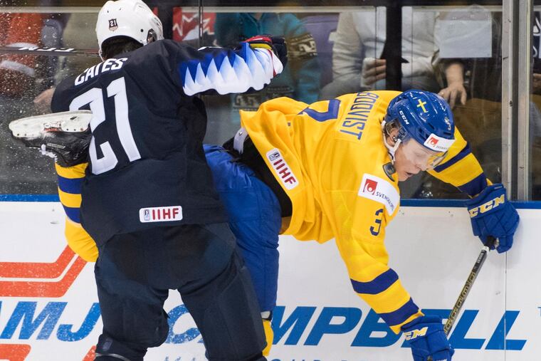 The United States' Noah Cates (21), pictured checking Sweden's Adam Boqvist (3) into the boards in a game on Dec. 29, scored the opening goal in the U.S.'s win over the Czech Republic Wednesday at the World Junior Championship in Vancouver. (Jonathan Hayward / The Canadian Press via AP)