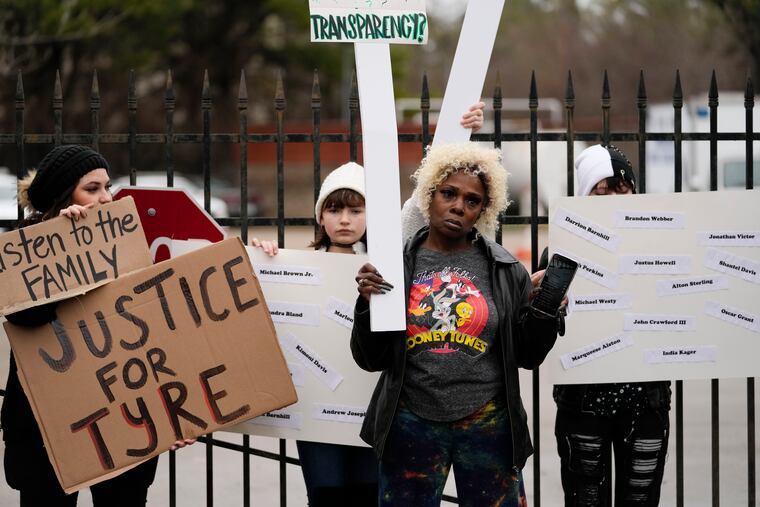 A group of demonstrators protest outside a police precinct in response to the death of Tyre Nichols, who died after being beaten by Memphis police officers, in Memphis, Tenn., on Sunday.