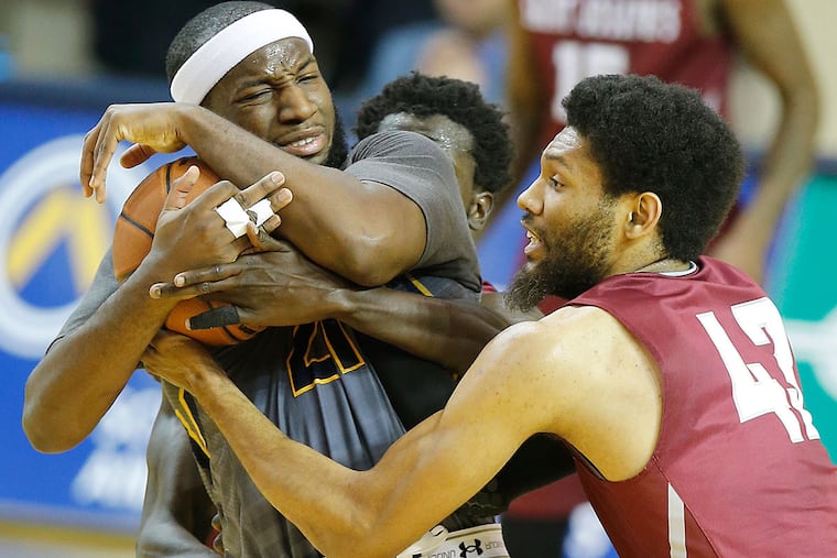 The pressing defense of DeAndre' Bemby, right, and Papa Ndao ties up La Salle's Jordan Price.