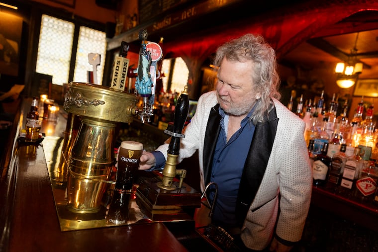 Fergus Carey pouring a Guinness at Fergie’s Pub in 2024.