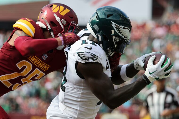 Eagles wide receiver A.J. Brown catching a touchdown pass late in the second quarter against Washington cornerback Benjamin St-Juste.