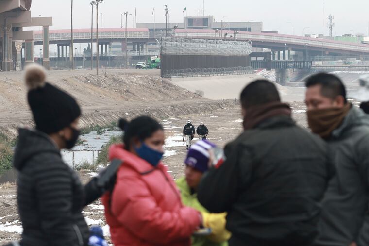 A Cuban migrant family is detained by National Guard soldiers along the Rio Grande in Ciudad Juarez, Mexico, Tuesday, Feb. 16, 2021. The number of people apprehended at the U.S.-Mexico border has increased since January and January was above December. This week families have been seen crossing from Ciudad Juarez and turning themselves over to Border Patrol.