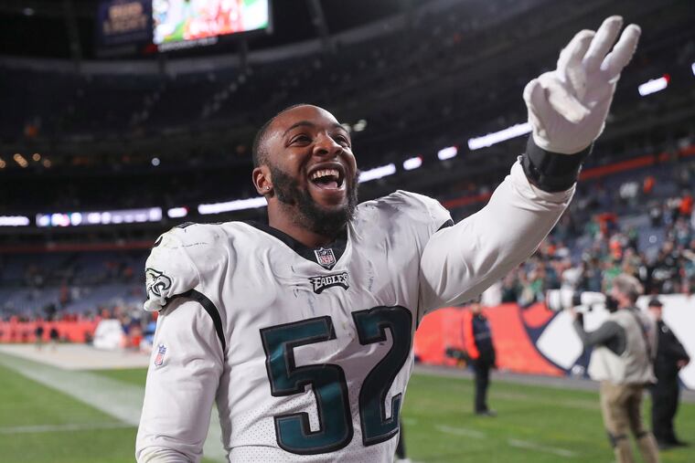 Davion Taylor (52) celebrates with fans after the Eagles' win over the Denver Broncos.