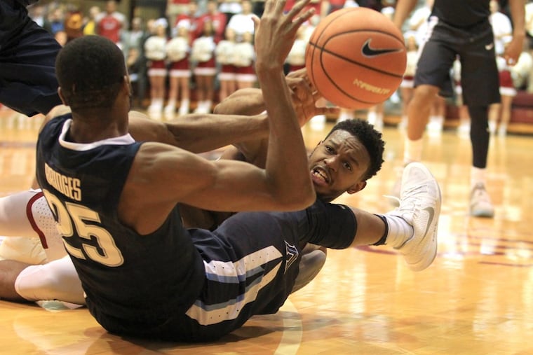 James Demery, right, of St. Joseph's and Mikal Bridges of Villanova scrambling for a loose ball on Dec. 2.