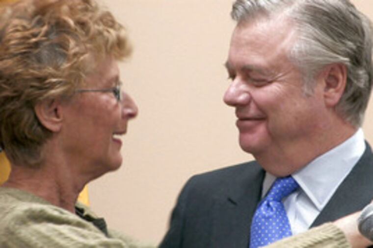 Carol Finkle hugs State Sen. Vincent J. Fumo after his announcement at the Convention Center that he would not seek a ninth term in office. Her group, Creative Access, gave Fumo an award for his work with hearing-impaired people.