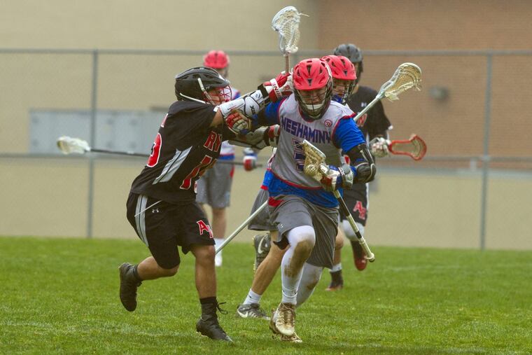 Archbishop Ryan's Jimmy Dolan (left) puts the pressure on Neshaminy's Dawson Obringer during a boys’ lacrosse game at Neshaminy High School in Langhorne, PA, Tuesday afternoon, April 3, 2018. Neshaminy won 18-8.