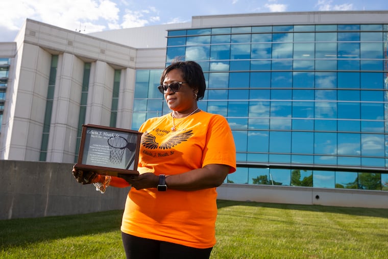 Crystal Heath's son, Edwin Heath, was shot and killed on May 13, 2015 in front of two of his children. The case, handled by New Castle County Delaware Police Department, is unsolved. Crystal is shown with his urn outside the New Castle County Public Safety Building on May 13, 2021.