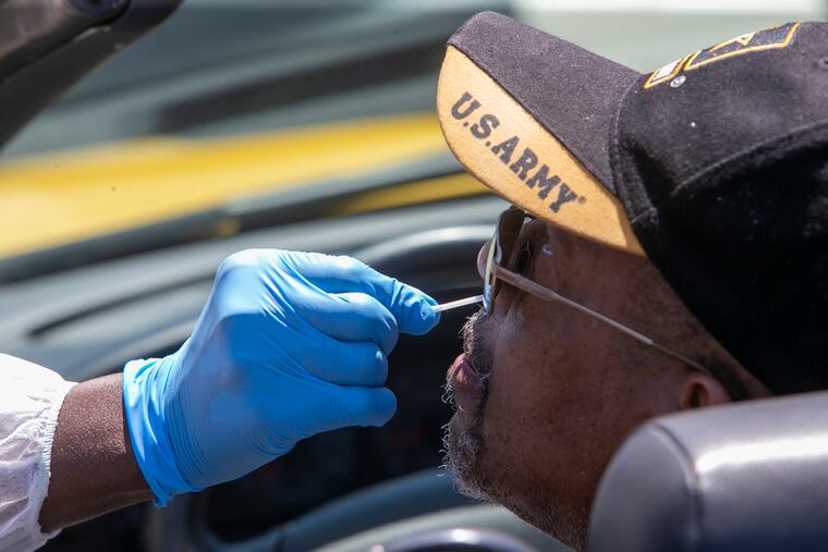 Dr. Ala Stanford tests Joel Watson of Philadelphia during a visit to the COVID-19 test site at Enon Tabernacle Baptist Church in 2020.