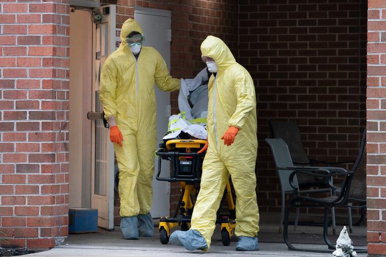 RESTRICTED - FOR PROJECT USE ONLY: Paramedic AJ Schifferli, left, and EMT Eric McKeever, right, wear full PPE with a patient at a nursing home in Bryn Mawr, PA, on April 17, 2020, in Ardmore, PA. .