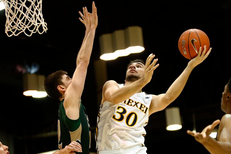 Drexel forward Alihan Demir shoots over William and Mary forward Paul Rowley in the first half of a Colonial Athletic Association basketball game Saturday, Jan. 5, 2019, at the Daskalakis Athletic Center. LOU RABITO / Staff