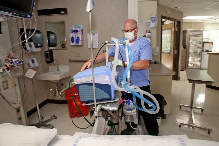 Glenn Ford, a respiratory therapist at Tyrone Hospital, moves one of their three ventilators to another room at Tyrone Hospital in Tyrone, Pa.