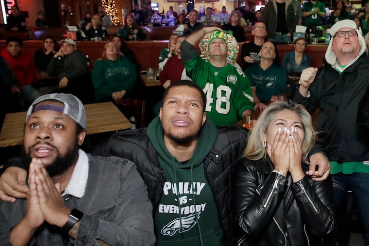 Eagles fans at Xfinity Live! watch a nailbiter as the Eagles defeat the Rams in a game last December.