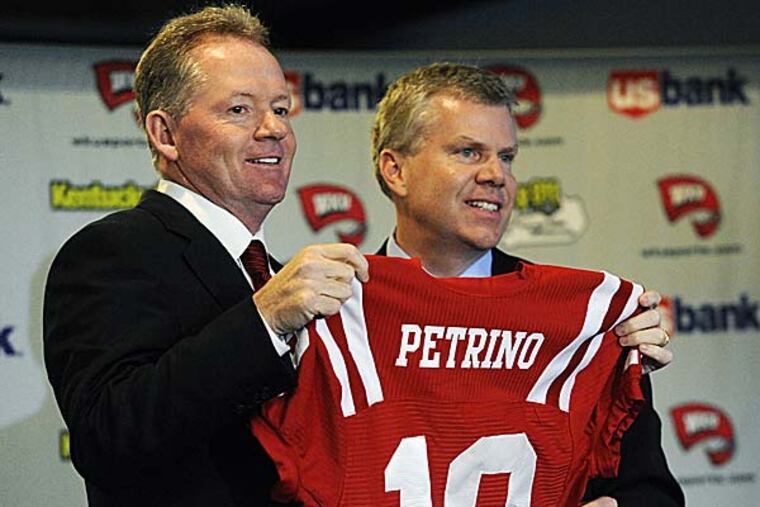 New Western Kentucky head coach Bobby Petrino, left, holds up a jersey with athletic director Todd Stewart during an NCAA college football news conference. (Joe Imel/AP)