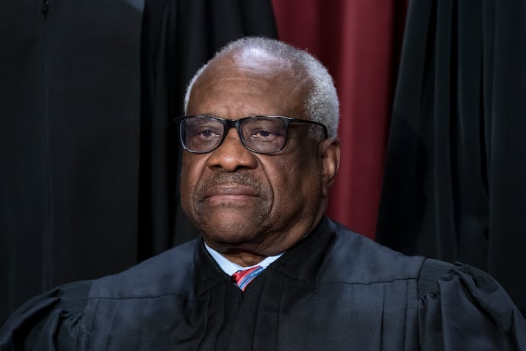 Associate Justice Clarence Thomas joins other members of the Supreme Court as they pose for a new group portrait, at the Supreme Court building in Washington in 2022.
