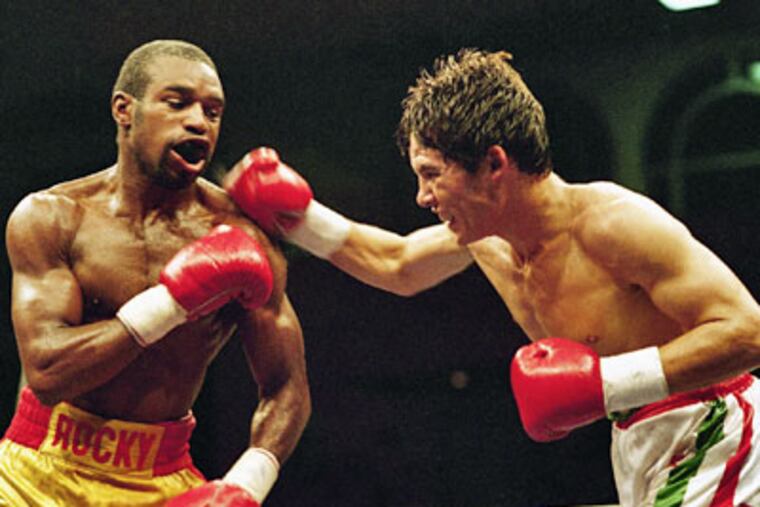 Junior Mexican lightweight world champion Julio Cesar Chavez delivers a right hook to Rocky Lockridge during their title fight Aug. 4, 1986, in Monaco. A year later, Lockridge became the International Boxing Federation's super featherweight champion. (AP Photo / Gilbert Tourte)